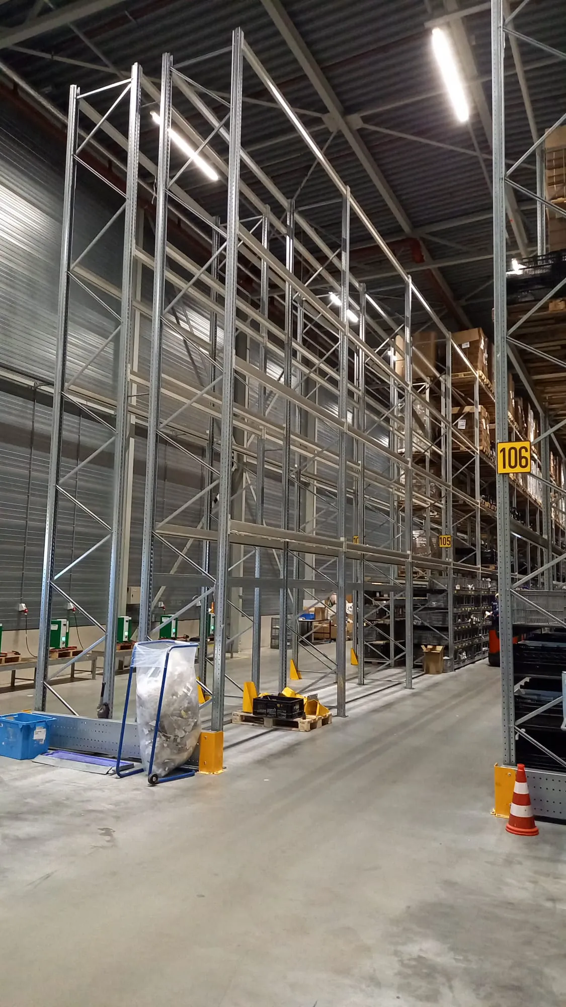 Montage van magazijnstellingen in een industriële omgeving met goed georganiseerde opslagruimtes